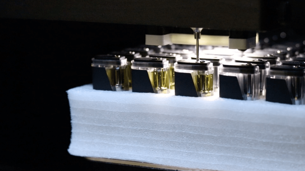 Close up of a Vape-Jet fully automatic filling machine filling disposables.